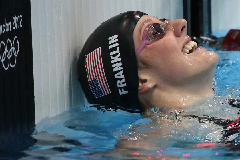 U.S. swimmer Missy Franklin smiles with a mixture of relief and joy after winning the women's 100-meter backstroke final at the London 2012 Olympics.