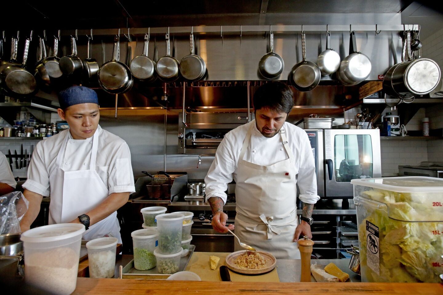 Chef Ludovic Lefebvre, right, works in the open kitchen with Ryan Wong. The restaurant is in a former Raffallo's Pizza.