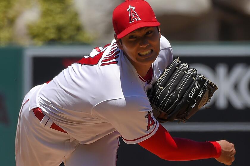 FILE - In this Aug. 2, 2020, file photo, Los Angeles Angels pitcher Shohei Ohtani, of Japan, throws during the second inning of a baseball game against the Houston Astros in Anaheim, Calif. Ohtani agreed to a two-year, $8.5 million contract with the Angels on Monday, Feb. 8, 2021, avoiding arbitration. (AP Photo/Mark J. Terrill, File)