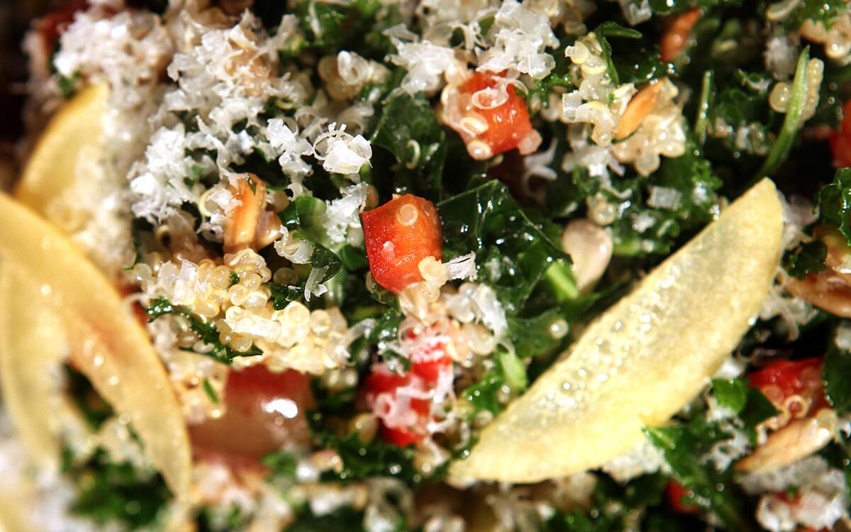 Dark green julienned strips of kale are tossed with nutty quinoa and sunflower seeds.