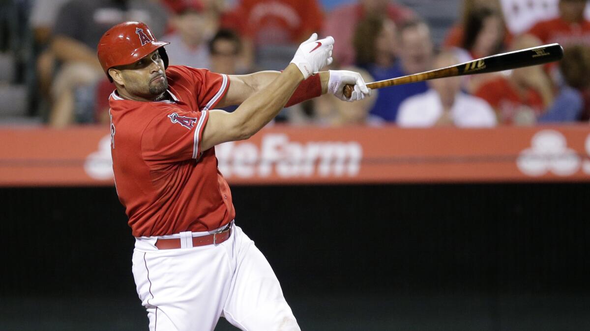 Angels first baseman Albert Pujols hits a two-run home run during the fifth inning of the Angels' 4-3 victory over the Houston Astros at Angel Stadium on Monday.