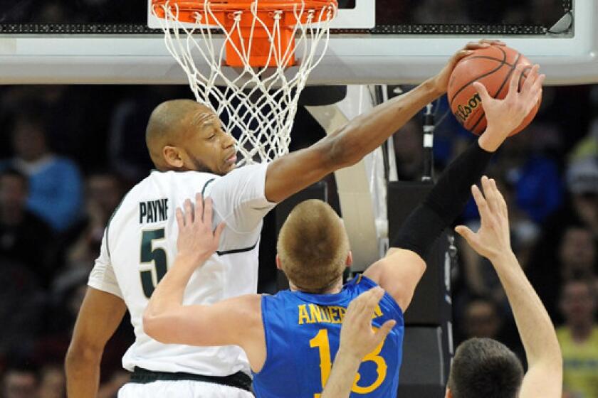 Michigan State's Adreian Payne blocks a shot by Delaware's Kyle Anderson during the Spartans' 93-78 win in the second round of the NCAA tournament on Thursday.