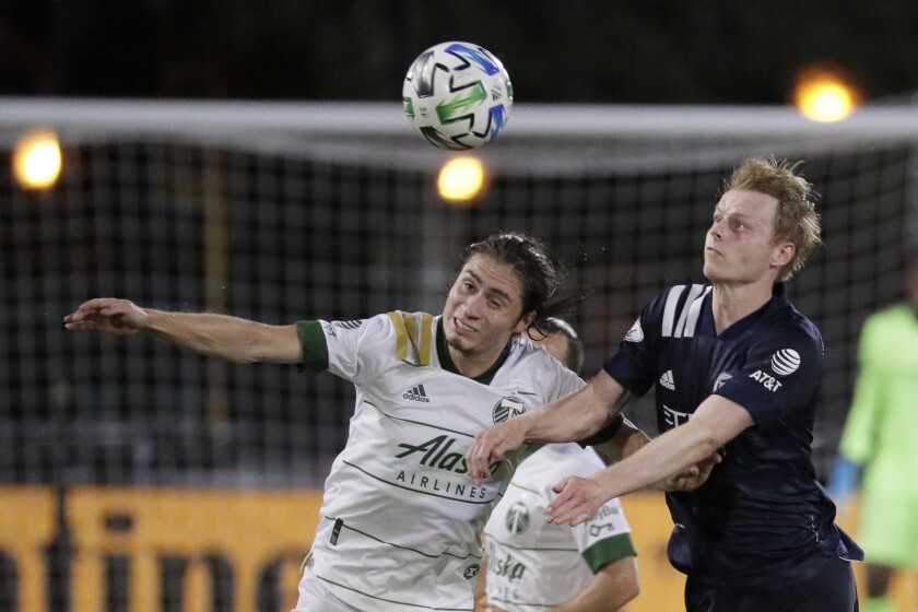 Portland Timbers defender Jorge Villafana, left, and New York City midfielder Gary Mackay-Steven battle for the ball during the second half of an MLS soccer match, Saturday, Aug. 1, 2020, in Kissimmee, Fla. (AP Photo/John Raoux)