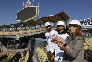 New Los Angeles Dodgers players David Price, left, and Mookie Betts tour new construction with Janet Marie Smith, Dodgers' senior vice president of planning and development after a news conference at Dodger Stadium in Los Angeles, Wednesday, Feb. 12, 2020. (AP Photo/Chris Carlson)