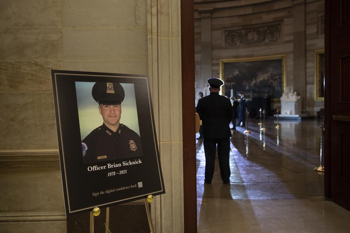 A placard on an easel with an image of Brian Sicknick at an entrance to the Capitol Rotunda