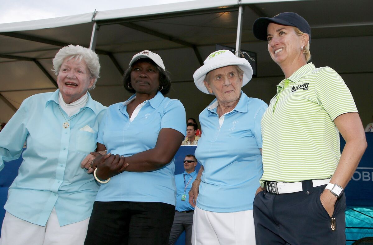 FILE - Karrie Webb, right, of Australia, poses with LPGA Founder Marilynn Smith, left, LPGA "Pioneer" Renee Powell, second from left, and LPGA Founder Shirley Spork, second from right, as Webb arrives for ceremonies after winning the LPGA Founders Cup golf tournament in Phoenix, in this Sunday, March 23, 2014, file photo. The tournament now is sponsored by New Jersey-based Cognizant, which chose to invest in men's and women's golf. (AP Photo/Ross D. Franklin, File)