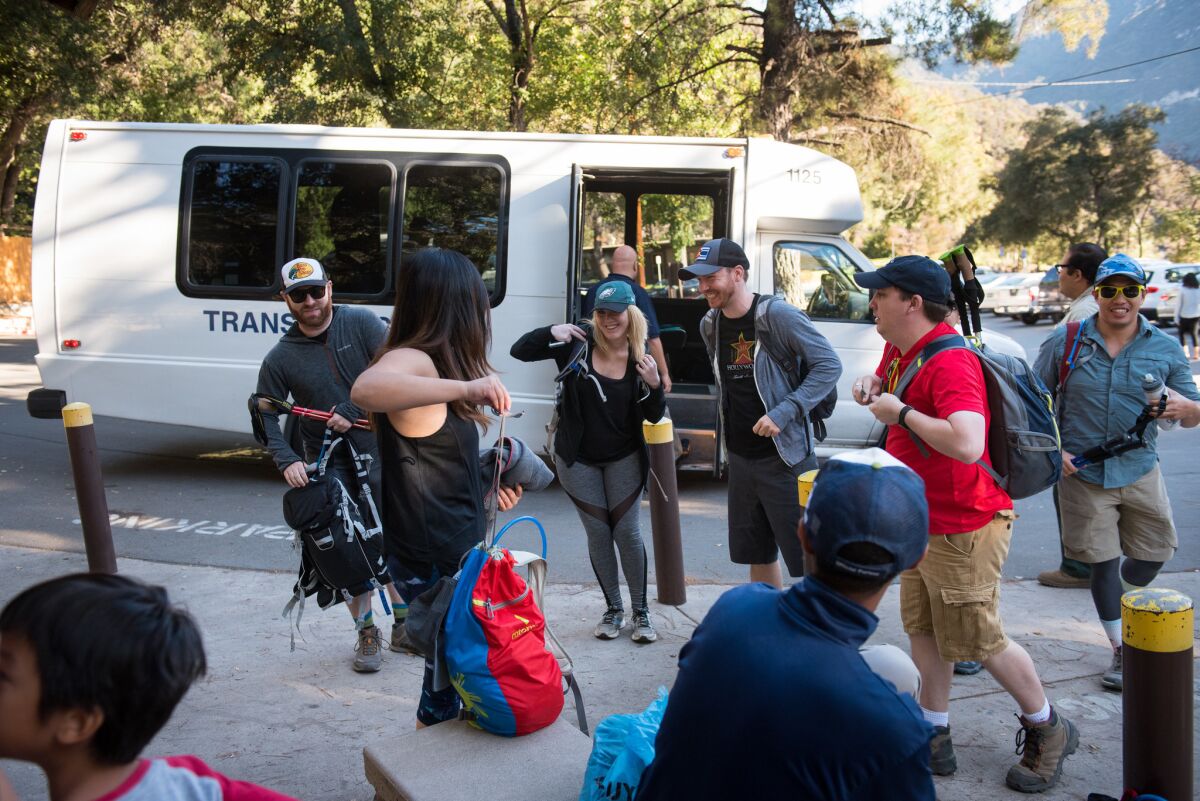 Hikers get ready to hit the trails after riding a shuttle bus from Arcadia to Chantry Flat in the San Gabriel Mountains.