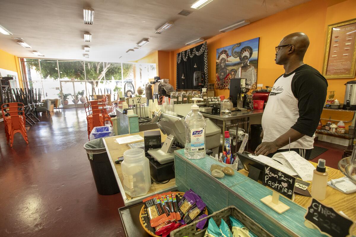 Tony Jolly, owner of Hot and Cool Cafe in South Los Angeles. The cafe is only doing take out orders and Jolly has seen an 80% decline in sales since the coronavirus pandemic broke out.