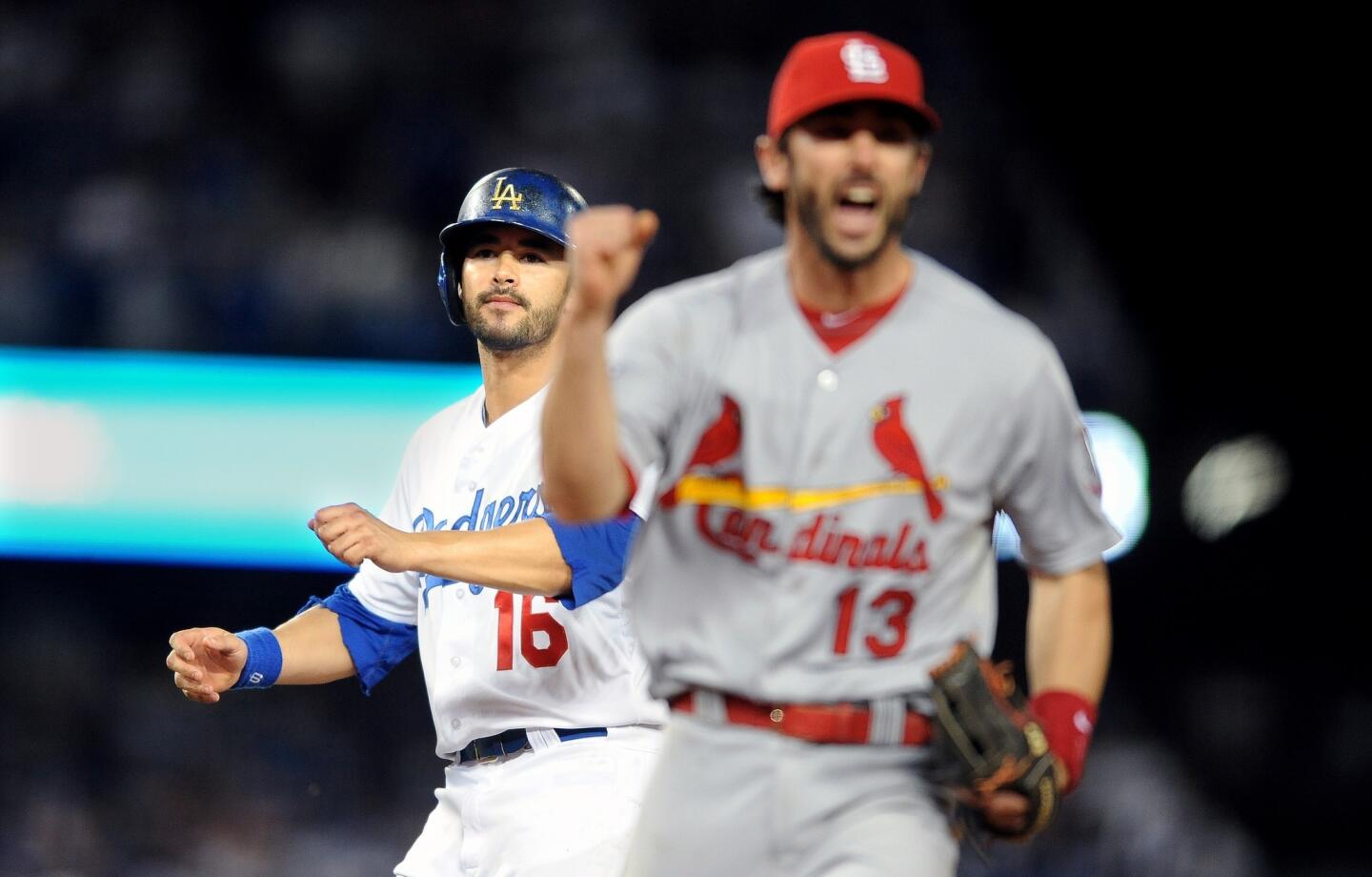 St. Louis second baseman Matt Carpenter celebrates in front of the Dodgers' Andre Either after completing a ninth-inning double play in the Dodgers' 4-2 loss in Game 4 of the NLCS.