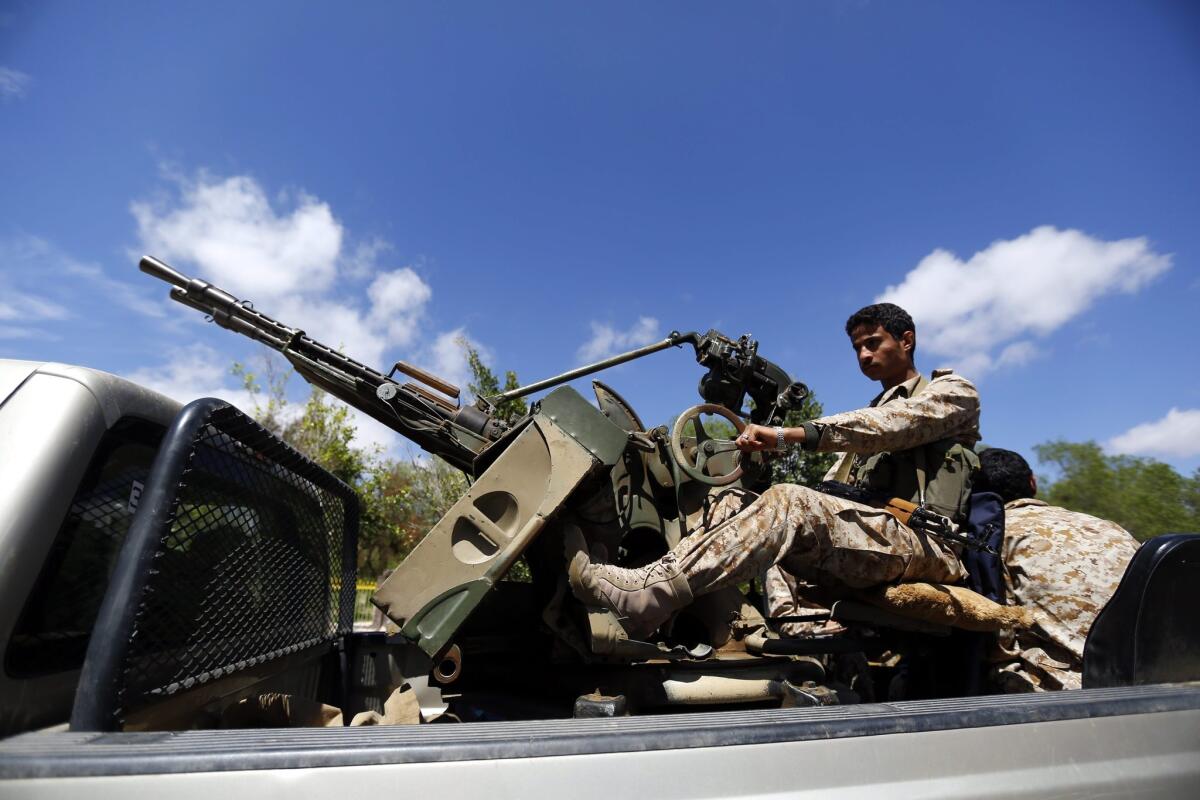 A Houthi fighter sits behind a machine gun on a truck patrolling a street as Houthi militias tighten security measures in Sana, Yemen, on March 24.