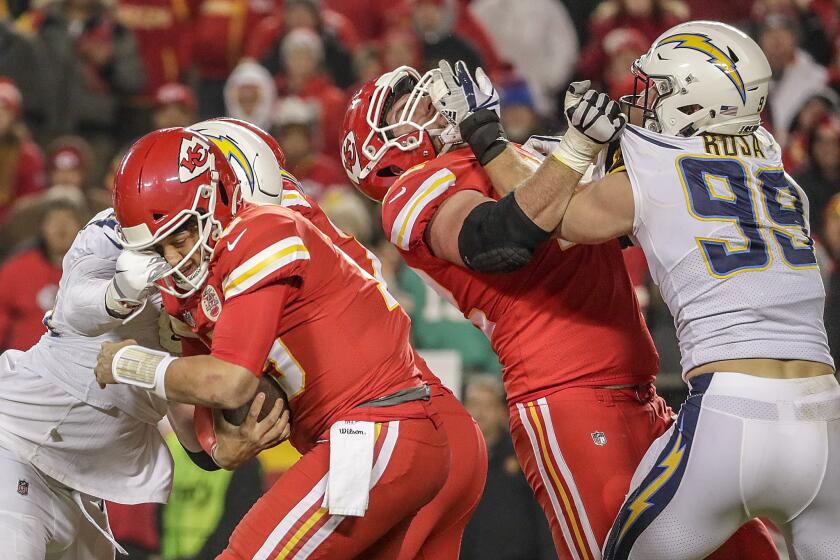 Chargers linebacker Melvin Ingram sacks Chiefs quarterback Patrick Mahomes as defensive lineman Joey Bosa wrestles with offensive lineman Eric Fisher.