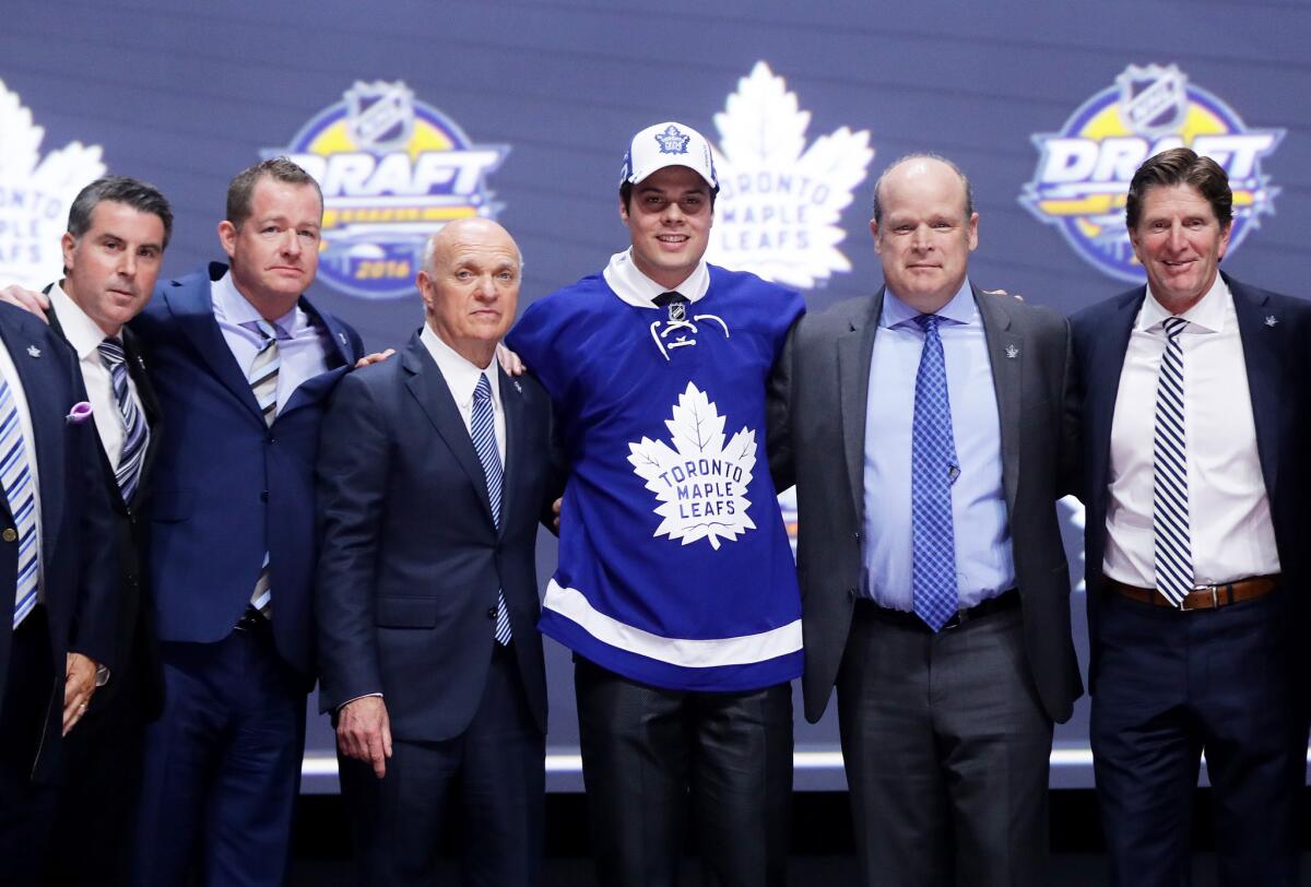 Auston Matthews, center in jersey, celebrates onstage with the Toronto Maple Leafs after being selected first overall in the 2016 NHL draft.