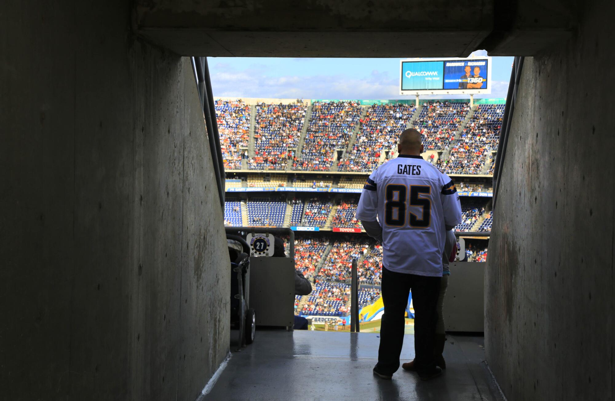 Chargers fan Charly Gallegos of San Ysidro, wearing an Antonio Gates number 85 jersey watches the game. 