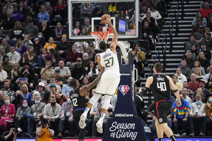 Utah Jazz center Rudy Gobert (27) dunks on Los Angeles Clippers guard Eric Bledsoe (12) in the second half during an NBA basketball game Wednesday, Dec. 15, 2021, in Salt Lake City. (AP Photo/Rick Bowmer)