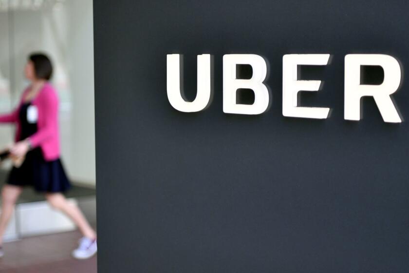 (FILES) In this file photo taken on February 5, 2018, a woman walks into the Uber Corporate Headquarters building in San Francisco, California. Ridesharing giant Uber is set to take over Jump Bikes, a bike-sharing startup offering dockless electric bicycles, both US firms announced on April 9, 2018. Jump and Uber were previously partners and 250 red bikes -- which could be picked up or dropped off anywhere using built-in GPS -- have been available through the Uber app in west San Francisco since the start of the year. / AFP PHOTO / JOSH EDELSONJOSH EDELSON/AFP/Getty Images ** OUTS - ELSENT, FPG, CM - OUTS * NM, PH, VA if sourced by CT, LA or MoD **