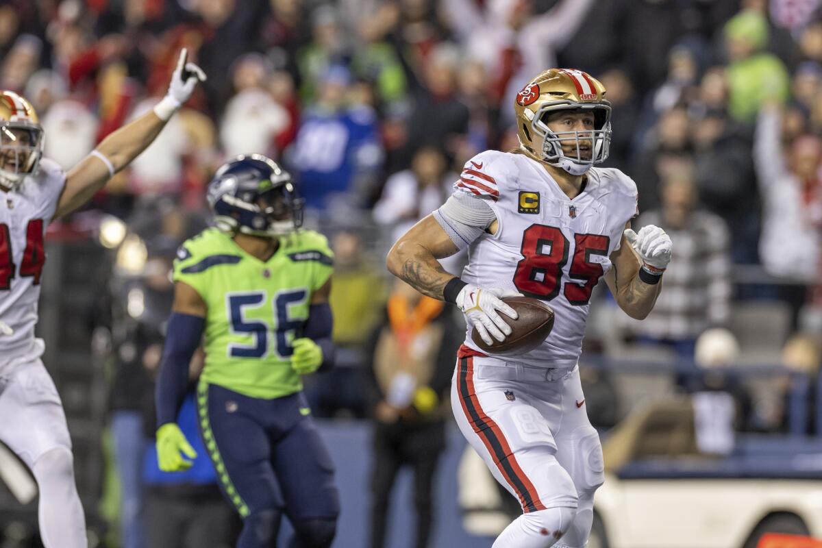 San Francisco 49ers tight end George Kittle catches a pass and runs for a touchdown against the Seattle Seahawks.