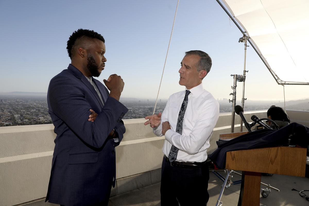 Eric Garcetti, right, talks with Michael Tubbs