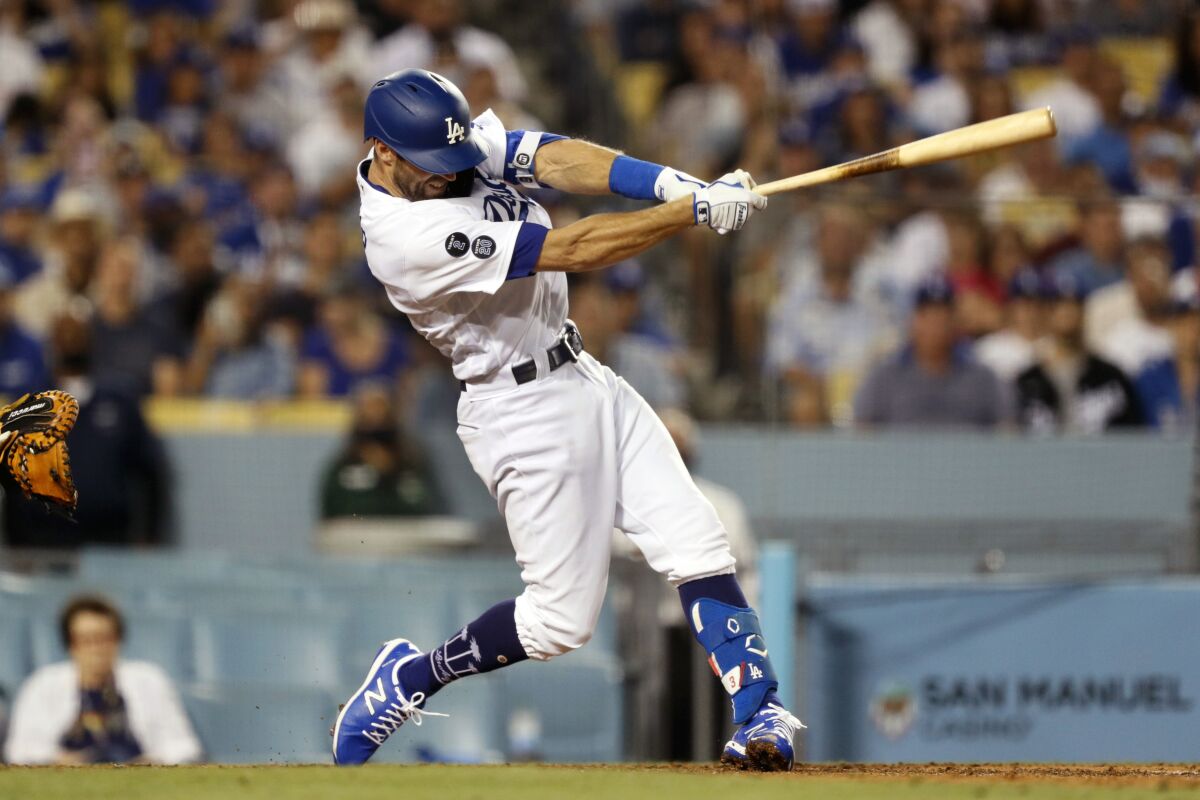 The Dodgers' Chris Taylor follows through on a go-ahead two-run double in the eighth inning.