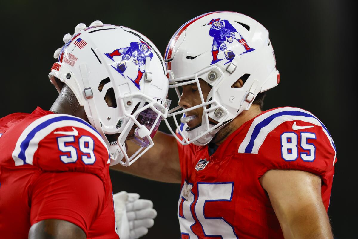 New England Patriots tight end Hunter Henry celebrates with offensive tackle Vederian Lowe after a touchdown.