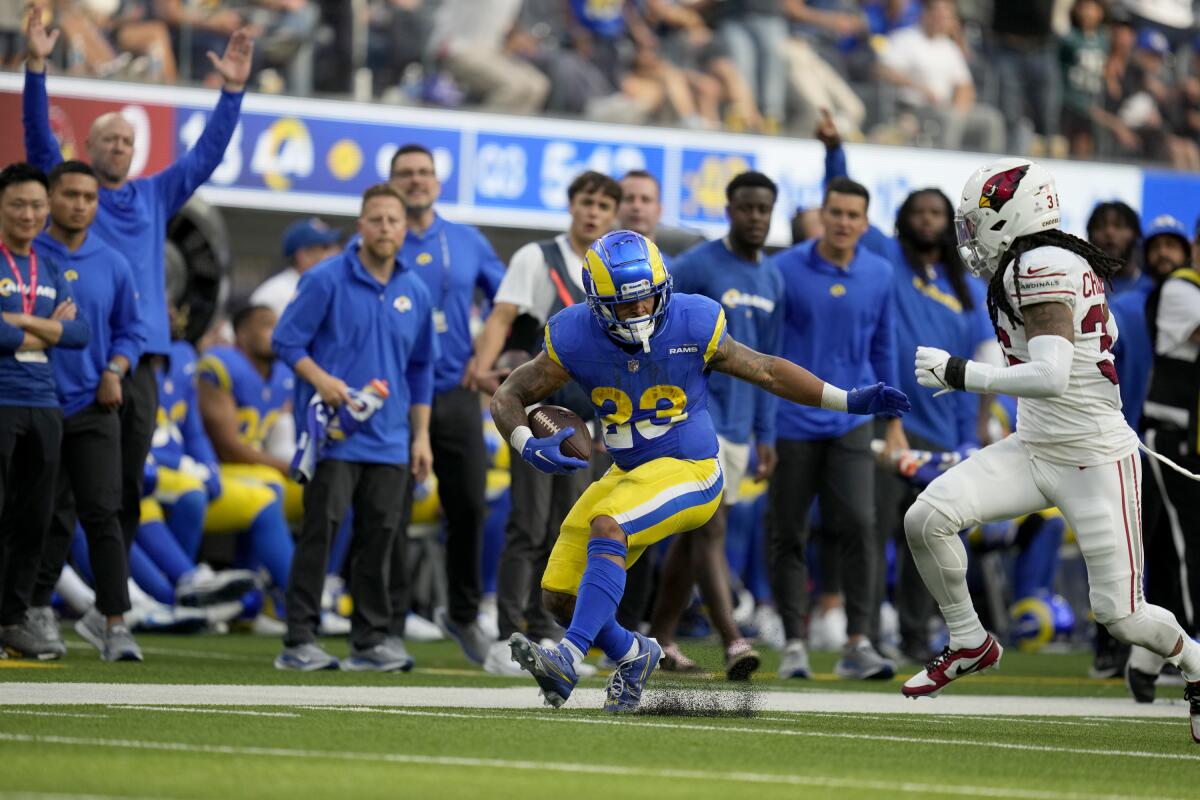 Rams running back Kyren Williams is chased by Arizona Cardinals safety Andre Chachere during the second half.