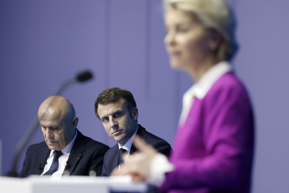 French President Emmanuel Macron, center, listens to European Commission President Ursula von der Leyen delivering her speech during the One Ocean Summit, in Brest, Brittany, Friday Feb. 11, 2022. World leaders are trying to save the planet's oceans in talks on France's Atlantic coast, aimed at fighting overfishing and plastic pollution, and finding fairer ways to manage the seas. (Ludovic Marin, Pool via AP)