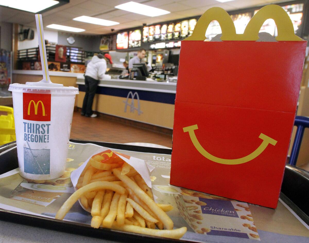 A Happy Meal with a drink and French fries is served at a McDonald's in Springfield, Ill. The fast-food giant says fewer U.S. customers since last July are choosing soda for their Happy Meals.