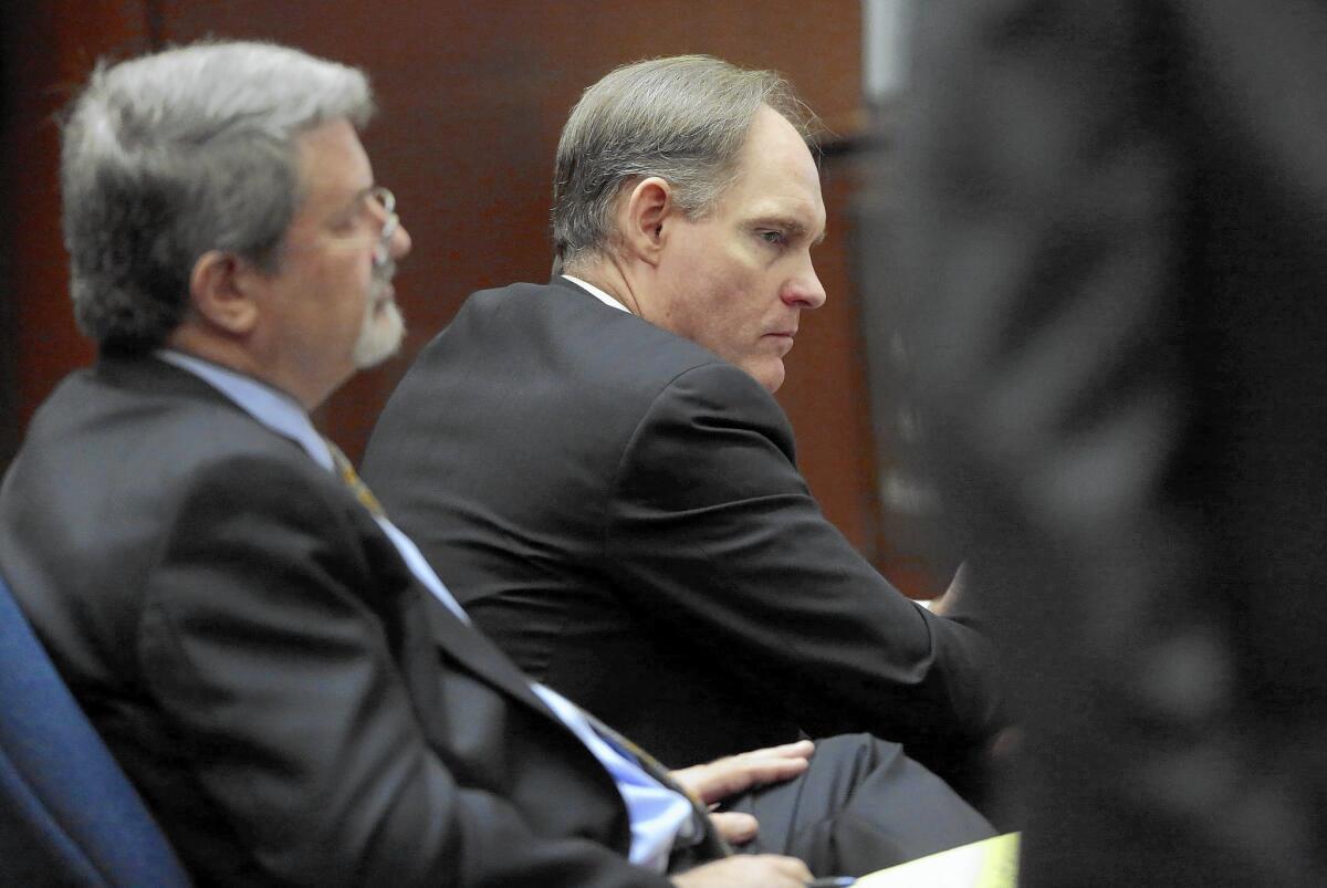 Attorney Aron Laub, left, listens with his client, Cameron Brown, as the murder trial gets underway.