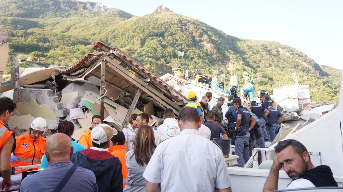 Rescuers work in the rubble of collapsed and damaged houses on Aug. 22, 2017, in Ischia, Italy.