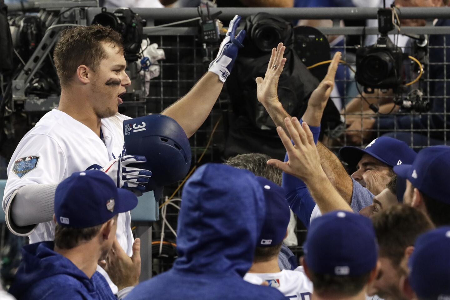Dodgers Joc Pederson celebrates in the dugout after homering in the third inning.