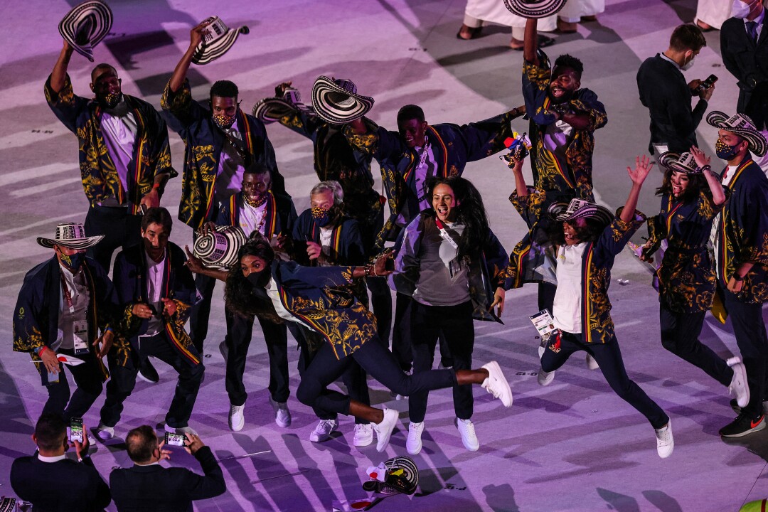 Team Colombia members leap into the air as their photo is taken