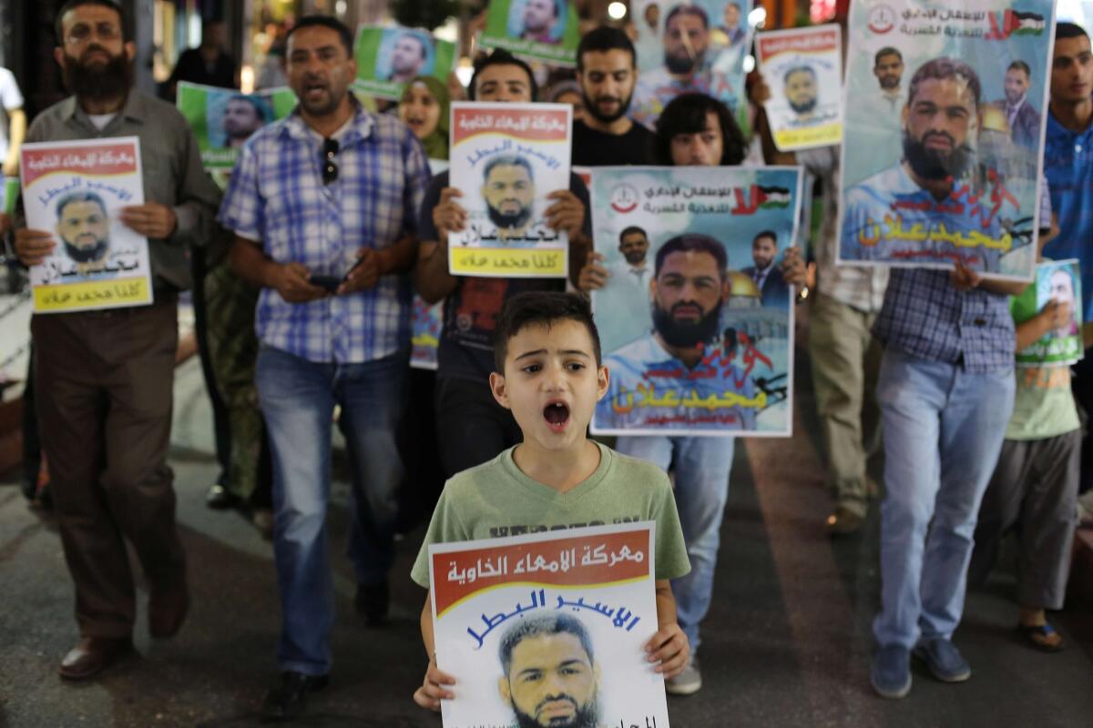 Palestinians rally in the West Bank city of Ramallah on Aug. 19, 2015, in a show of support for Mohammed Allan. The Palestinian activist, 31, has been rearrested by Israel.