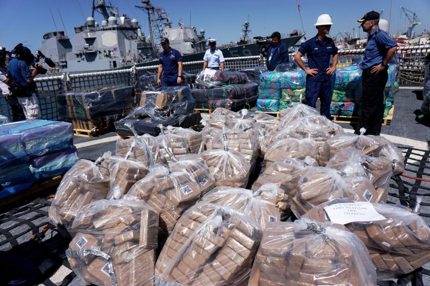 Bales of cocaine seized from smugglers by U.S. and Canadian personnel were unloaded from the Coast Guard cutter Boutwell. The 28,000 pounds of cocaine had a wholesale value of $424 million.