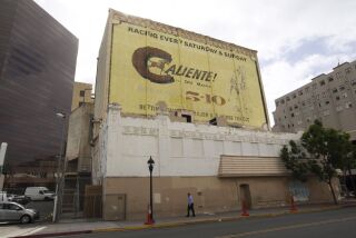 The fate of a large painted billboard advertising horse racing at Tijuana's Caliente race track on the west side of the now closed and historically designated California Theater downtown and at least one other sign are up for a vote on Thursday, pitting preservationists against developers.