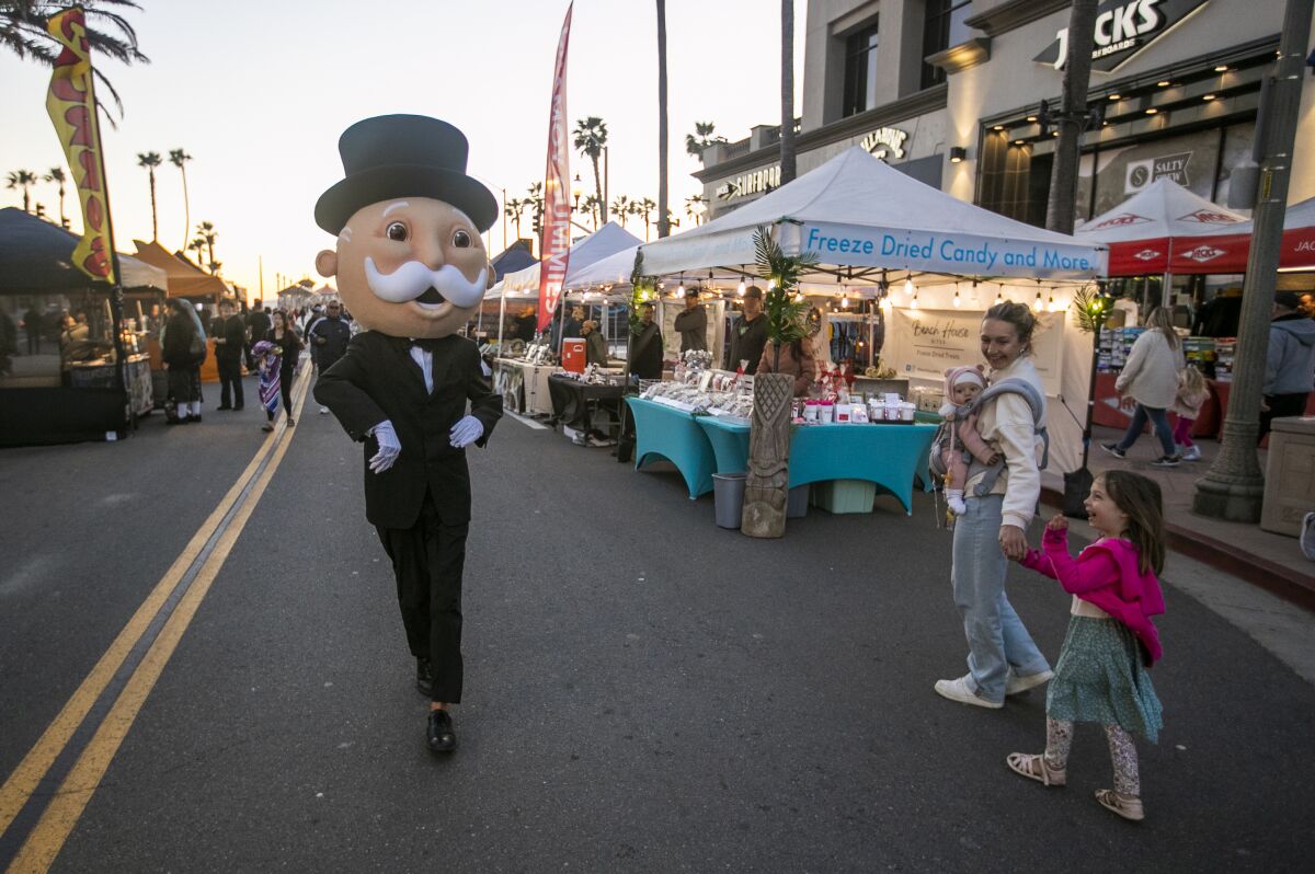 Mr. Monopoly, the iconic character who represents the board game, walks around Surf City Night in Huntington Beach.