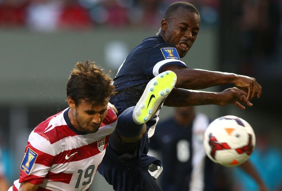 Belize's Elroy Smith, right, can't stop Chris Wondolowski of the United States from heading in his third goal of the first half during the USA's 6-1 victory.