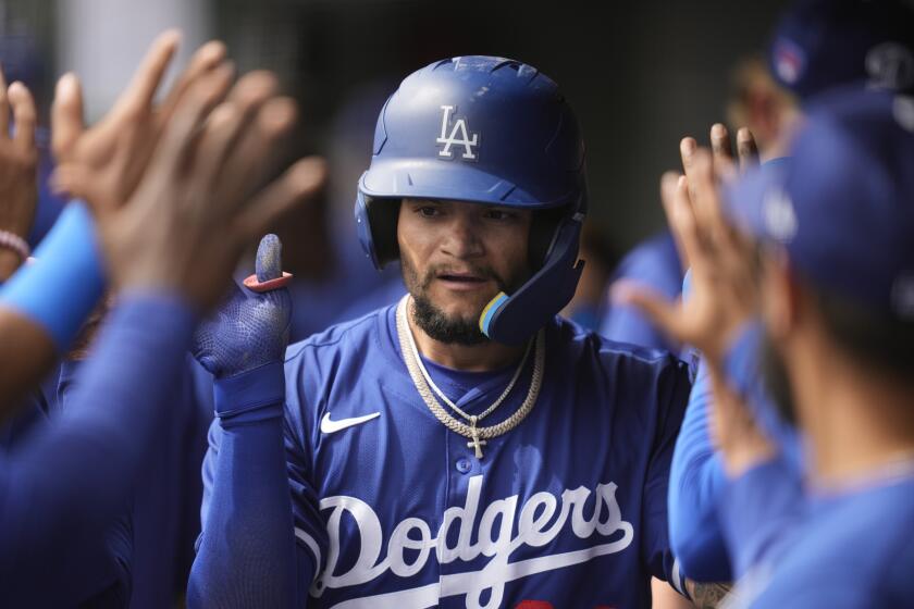 Los Angeles Dodgers' Andy Pages celebrates after scoring off of a throwing error by Chicago White Sox catcher Max Stassi during the second inning of a spring training baseball game in Phoenix, Wednesday, March 6, 2024. (AP Photo/Ashley Landis)