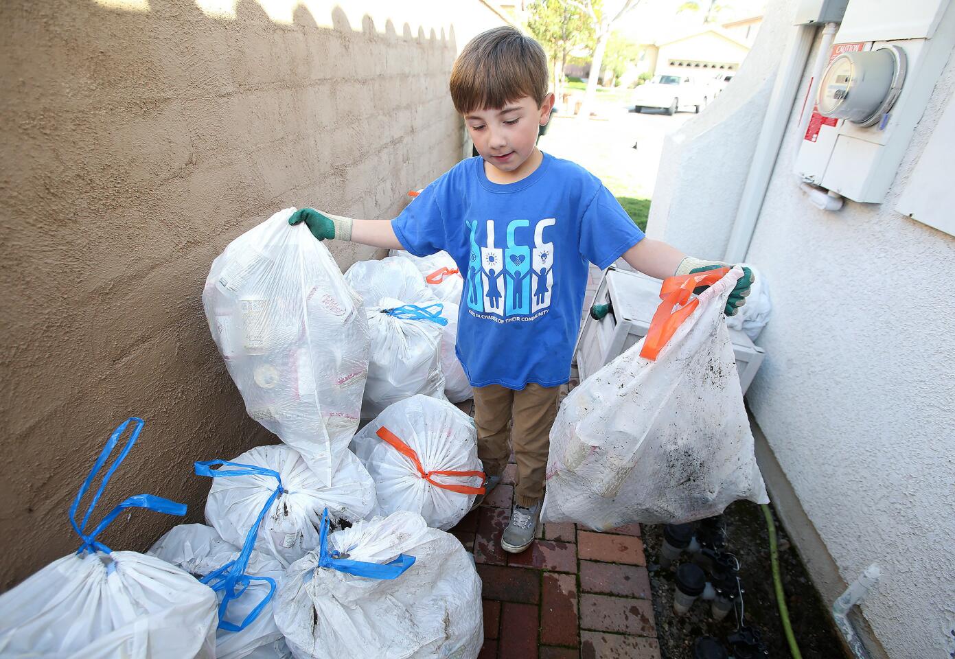 Ryan Hickman, 9, begins the task of sorting cans, glass and plastic bottles for his company, Ryan's Recycling, at his home in San Juan Capistrano. He has donated more than $8,400 to the Pacific Marine Mammal Center in Laguna Beach.