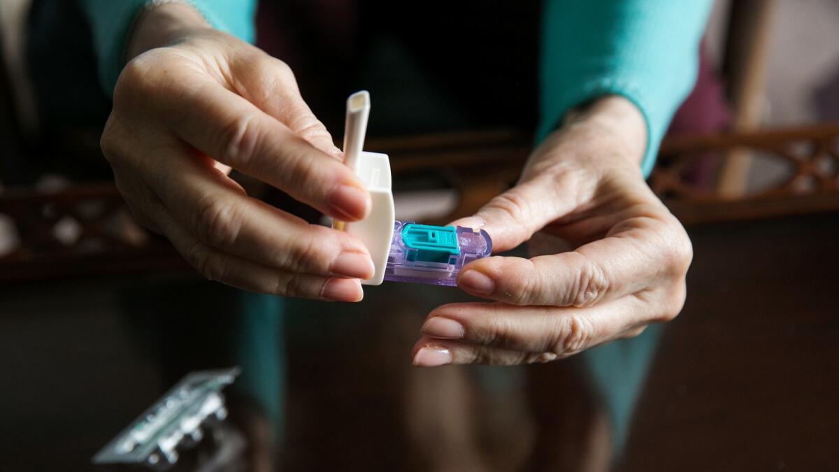 In this 2015 photo, Cynthia Goldstein of Los Angeles demonstrates MannKind Corp.'s inhalable insulin drug, Afrezza. The company has struck a deal to develop and commercialize a drug for pulmonary hypertension using similar inhalable technology.