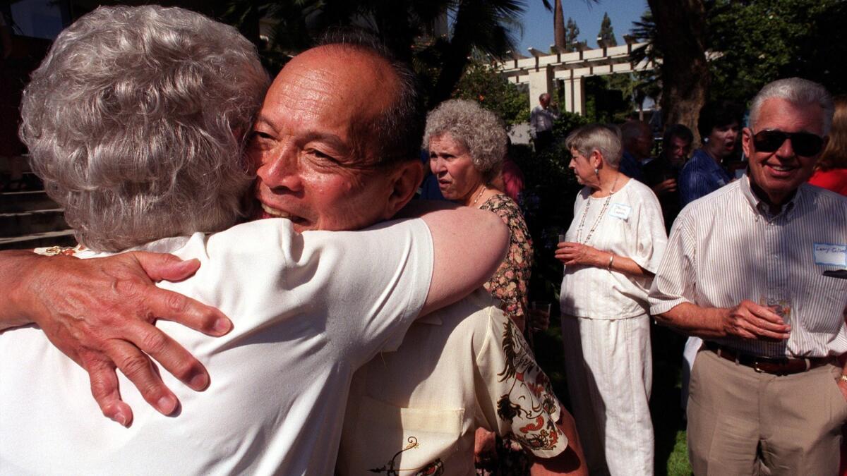 Pasadena civic leader Al Lowe, 73, receives a hug from former Pasadena Mayor Katie Nack at a farewell celebration for Lowe and his wife, Rose Marie, at the Tournament House in Pasadena Sunday afternoon.