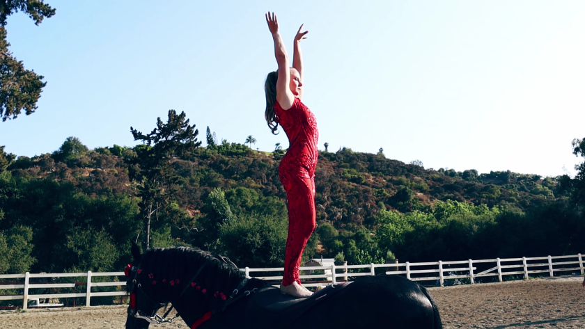 Anna Kataoka, 43, practices contortion skills from the back of her horse, CM Castizo.