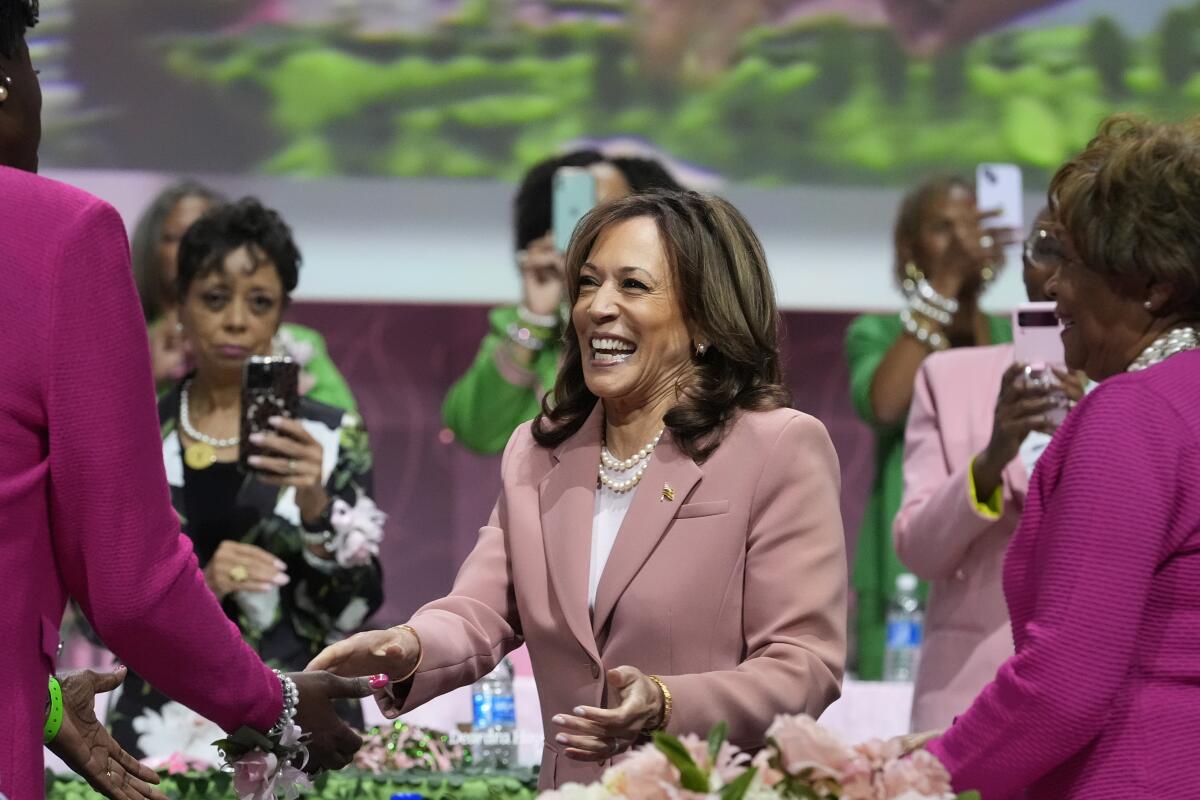 Kamala Harris, center, is greeted at the Alpha Kappa Alpha sorority summit as women record her on their phones