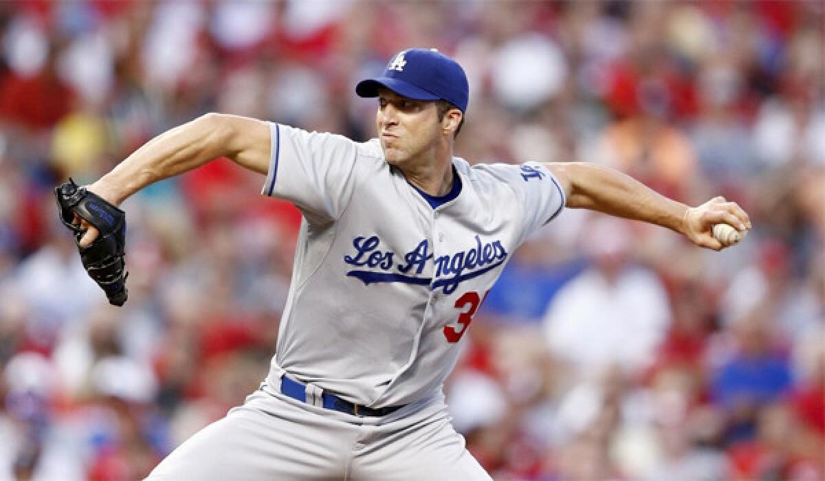 Left-hander Chris Capuano looked sharp pitching for the first time since Sept. 6 in the Dodgers' 11-0 victory over the Colorado Rockies on Friday.