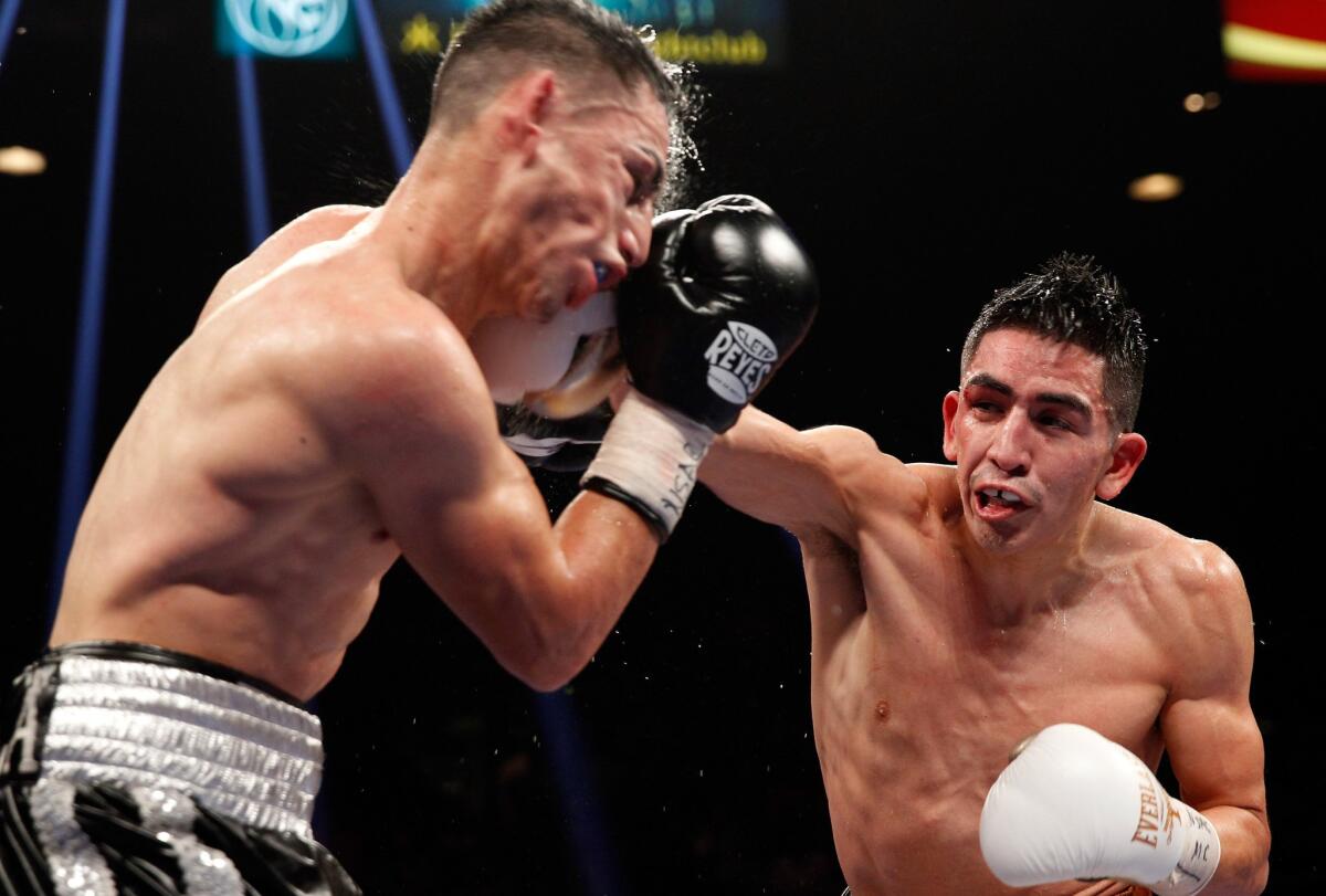 Leo Santa Cruz lands a right hand to the face of Jesus Ruiz during their super-bantamweight title fight on Saturday night at the MGM Grand Garden Arena.
