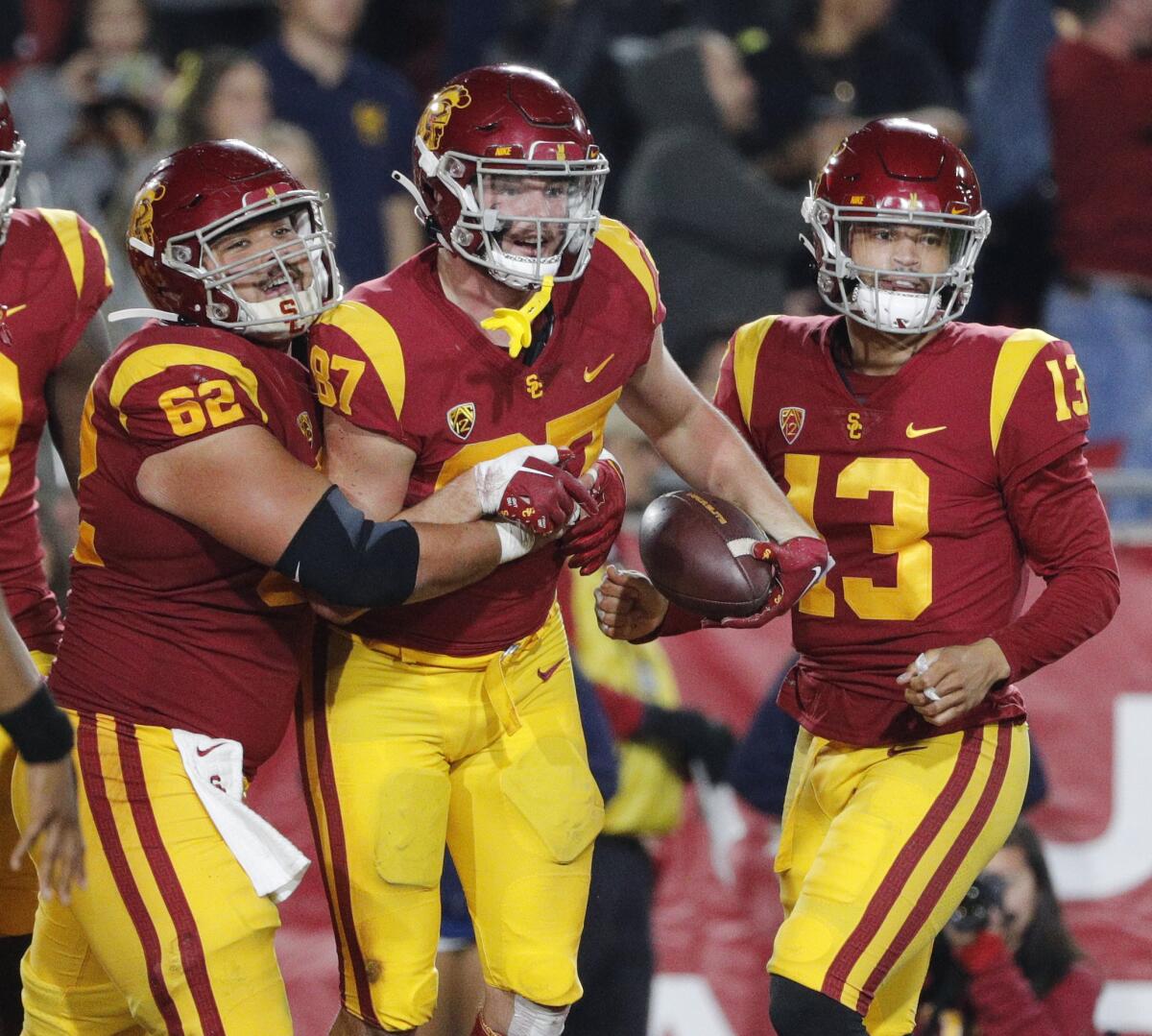 USC tight end Lake McRee is congratulated by lineman Brett Neilon and quarterback Caleb Williams after scoring a touchdown.