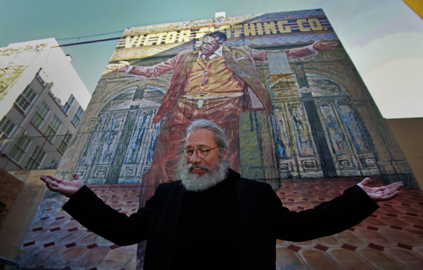 Actor Edward James Olmos celebrates the beginning of restoration efforts in 2014 for the 70-foot-tall "Pope of Broadway" mural featuring Anthony Quinn with his arms outstretched over downtown Los Angeles.