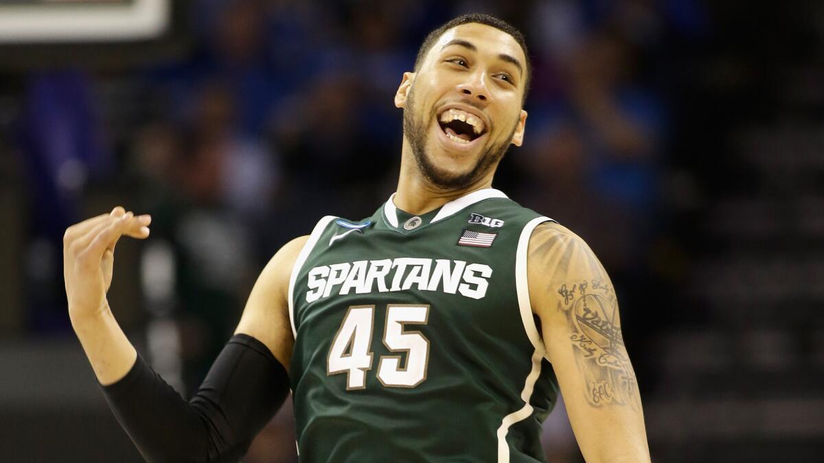 Michigan State's Denzel Valentine celebrates the Spartans' 60-54 win over Virginia in the third round of the NCAA tournament on Sunday.