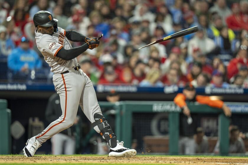 San Francisco Giants' Jorge Soler breaks his bat as he hits into a double play but a run will score for the Giants during the seventh inning of a baseball game against Philadelphia Phillies, Friday, May 3, 2024, in Philadelphia. The Phillies won 4-3. (AP Photo/Chris Szagola)