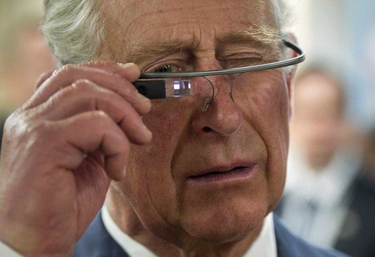 Britain's Prince Charles tries on Google Glass during a tour of Winnipeg, Canada, in May.