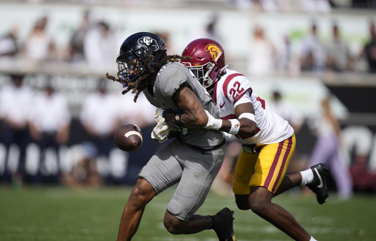 Colorado wide receiver Xavier Weaver drops a pass while tackled by USC cornerback Ceyair Wright.