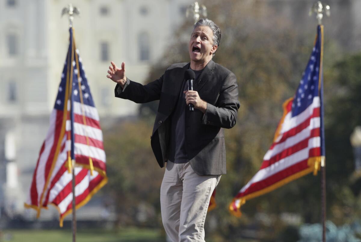 Comedian Jon Stewart shouts to the crowd during the Rally to Restore Sanity and/or Fear on the National Mall in Washington.